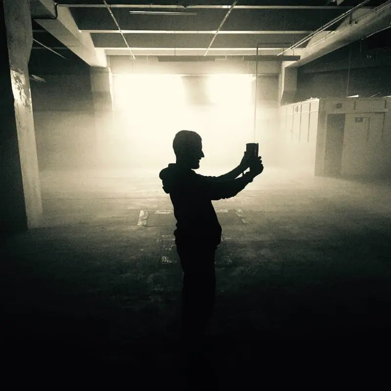 Factory Picture of man taking photo on mobile