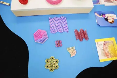 close up of 3D printed jewellery on blue table