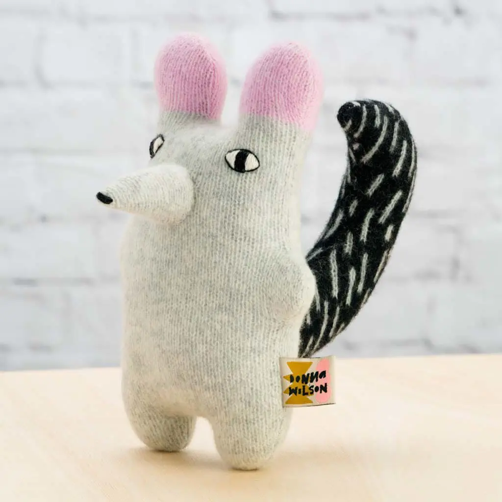 a white bunny with a yellow tag