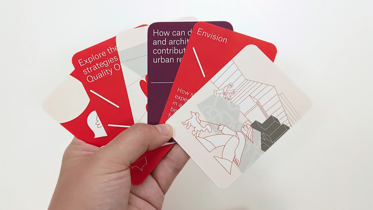 A hand holds a set of playing cards, spread out as if ready to play a game.